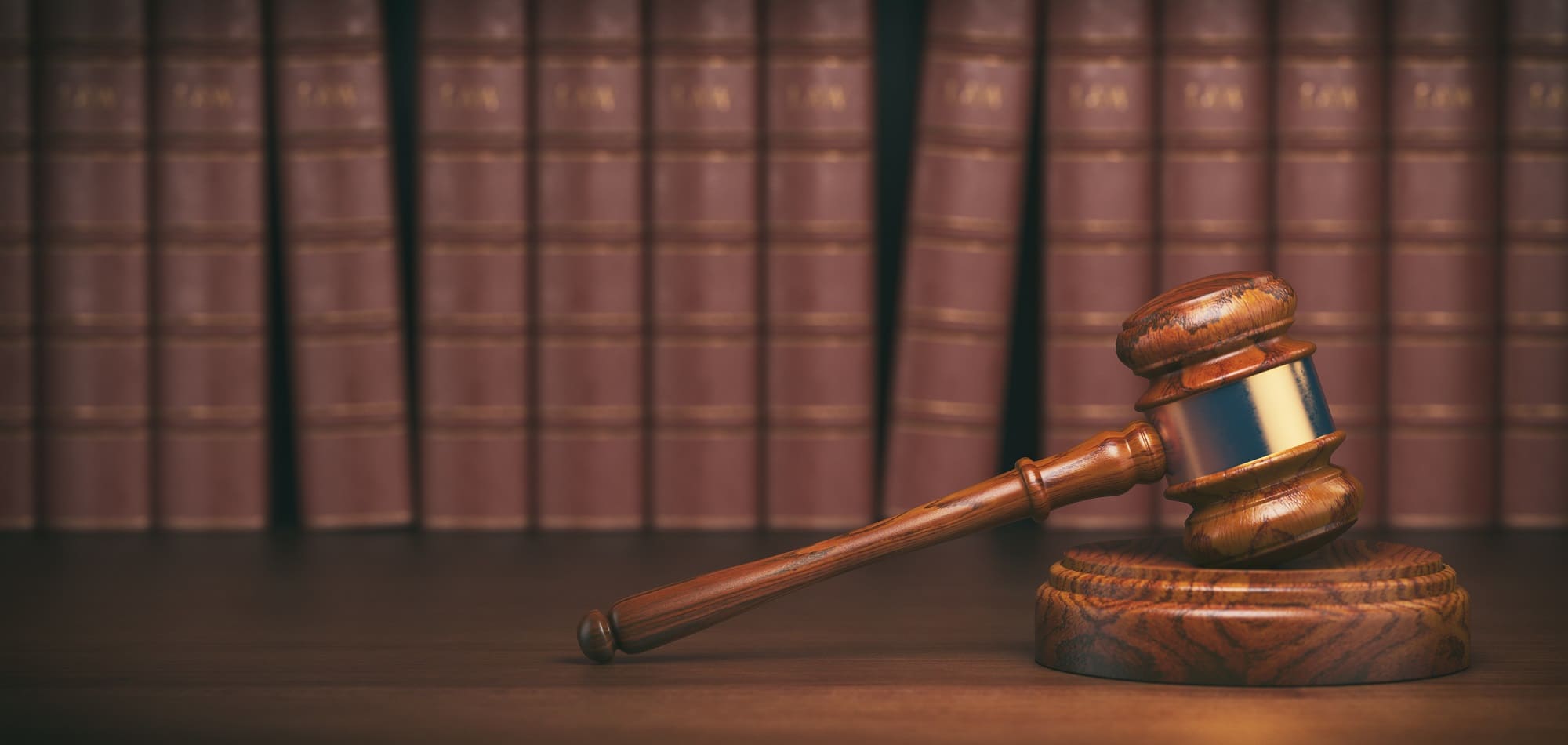 A judge's gavel surrounded by law books