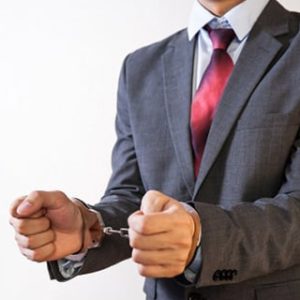a man in a suit handcuffed