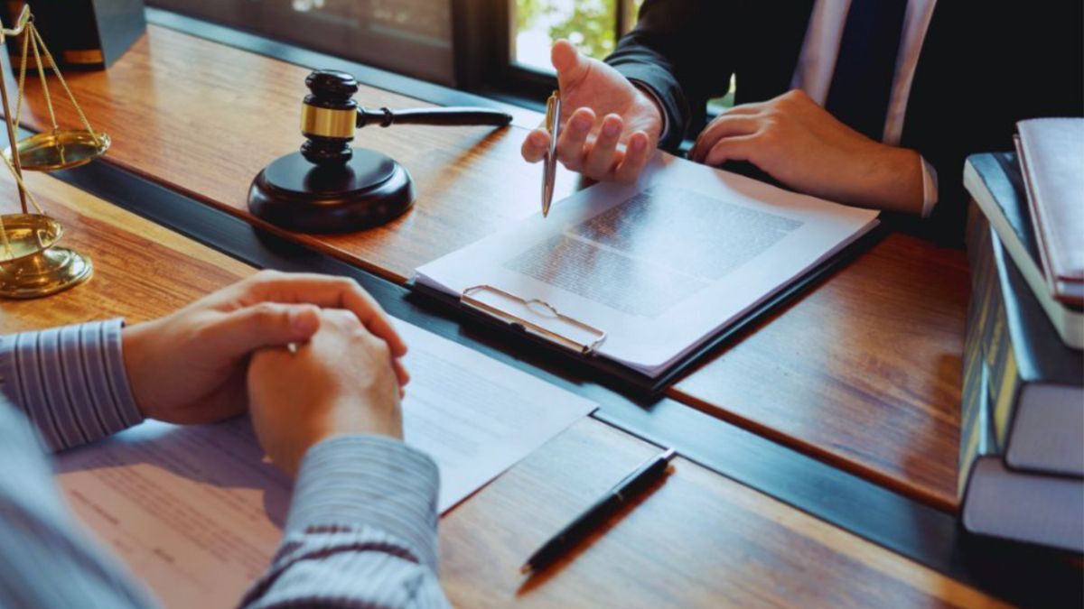 A Louisiana criminal defense attorney and their client reviewing documents related to an assault case in Baton Rouge.