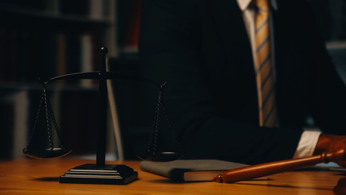 A courtroom scene features a lawyer focused on a murder defense, with the scales of justice and a gavel nearby.