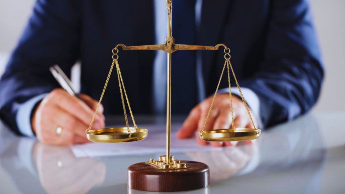 A compassionate sexual assault defense lawyer in a suit, taking notes in an office, symbolizing dedication and personal attention to clients.