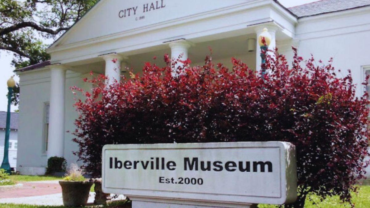 The Iberville Museum showcases its stunning architecture, surrounded by lush greenery.