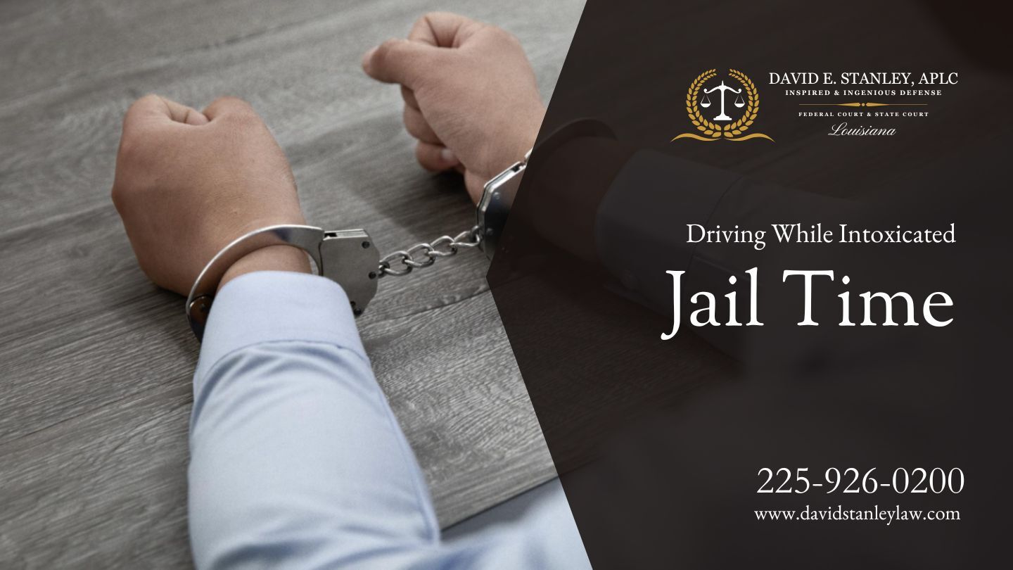A man restrained in handcuffs sits on a wooden table.