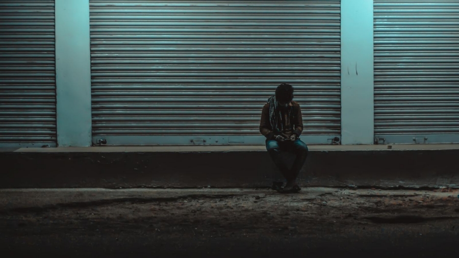 Person sitting alone at night while facing criminal charges