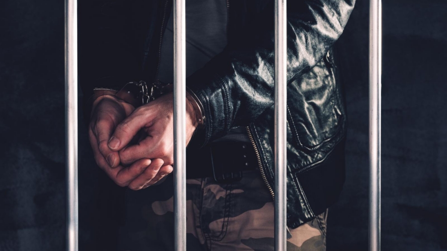 Handcuffed man behind bars awaiting a bail hearing in Louisiana