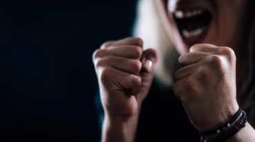 Person with clenched fists in a moment of rage