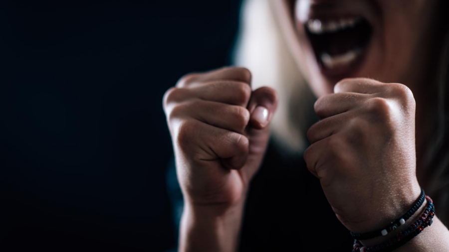 Person with clenched fists in a moment of rage