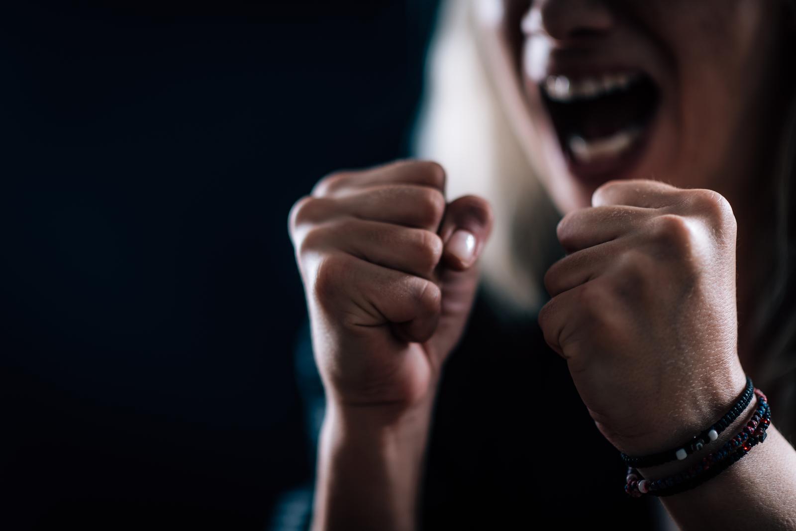 Person with clenched fists in a moment of rage