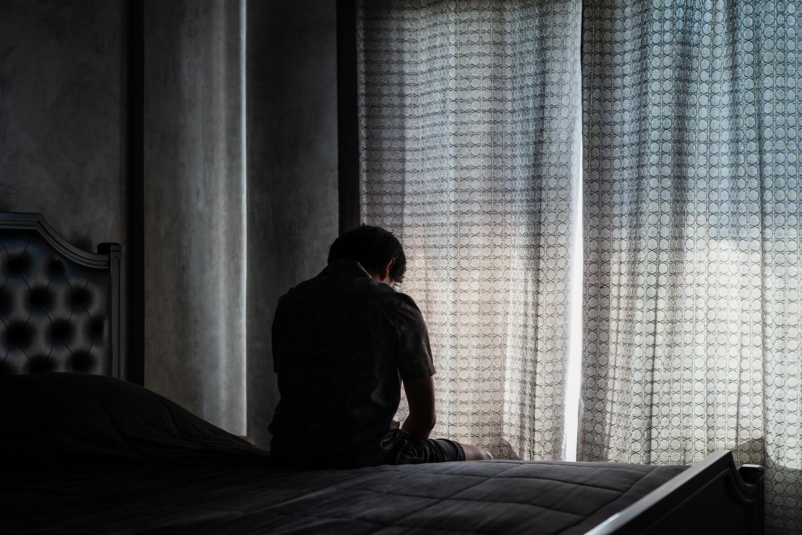 Person sitting quietly at home while under criminal investigation